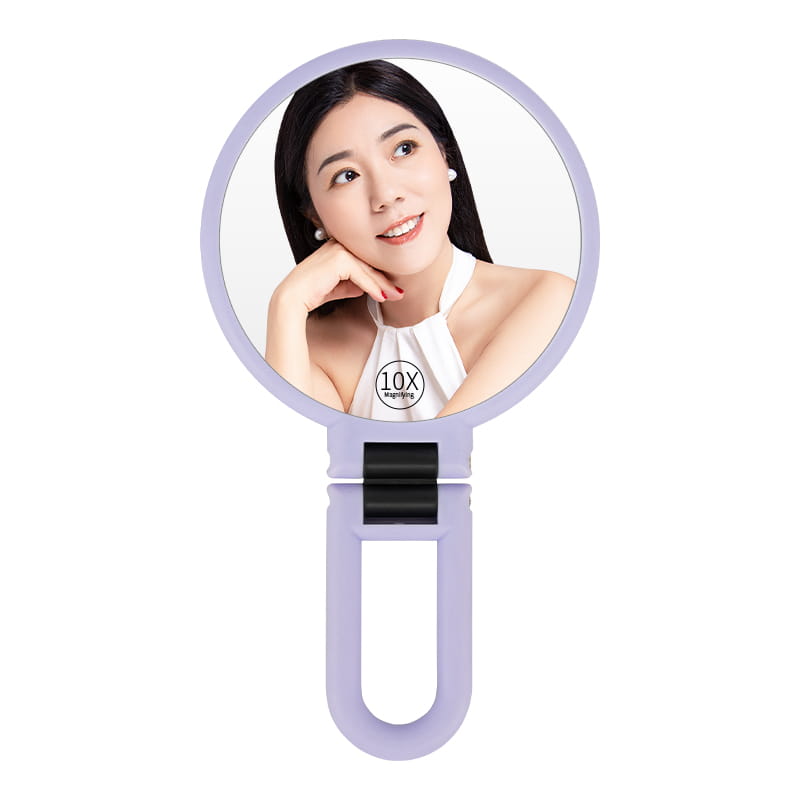 A lavender-colored handheld 10x magnifying foldable handle mirror purple with a sleek modern design and black clip mechanism.