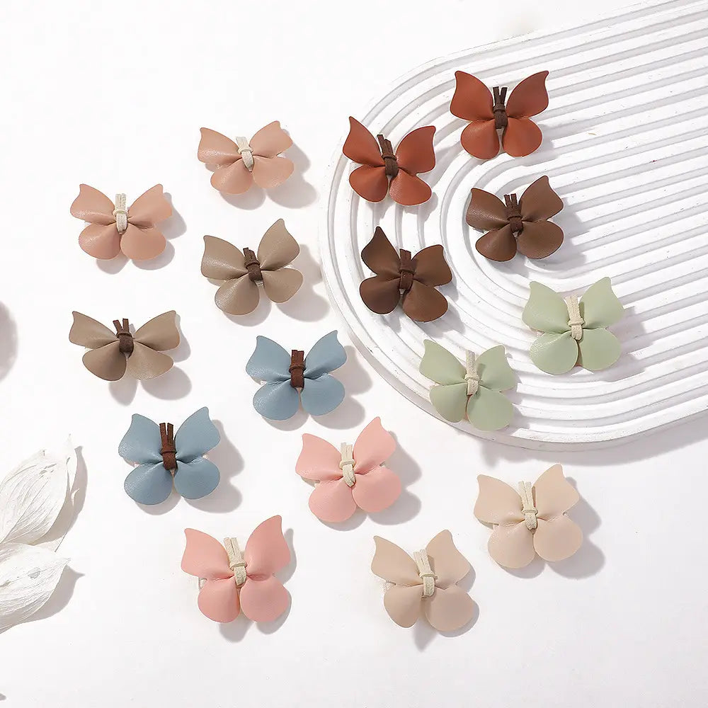 pastel leather butterfly bag clip children’s barrettes made of soft leather with pastel colors and brown fabric centers