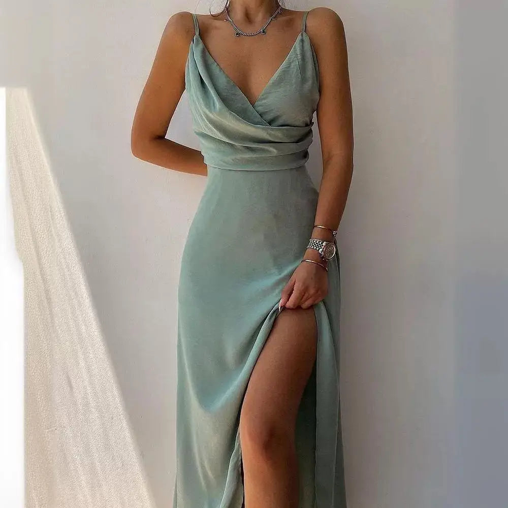 A flowing sage green satin slit sling dress with a deep v neckline and high slit perfect for dress summer fashion.