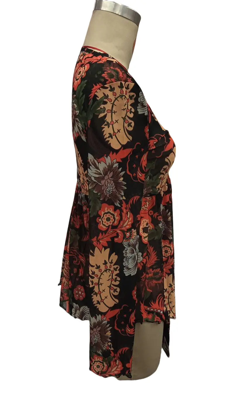 A black floral print mesh printed romper with red and beige paisley patterns featuring a knotted flare sleeve displayed on a mannequin.