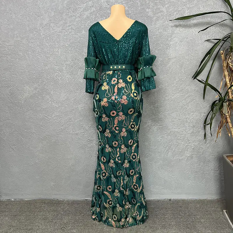 Emerald green half sleeve slim fit evening dress featuring a round neck shirt design with sequined floral embroidery and ruffled sleeves.