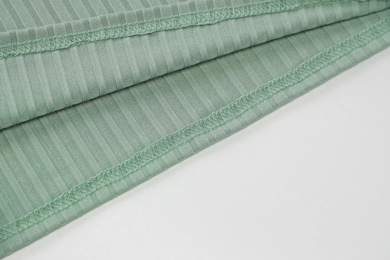Olive green stripe knitted women sleeveless dress featuring light green ribbed fabric with a subtle striped pattern and neatly finished edges.