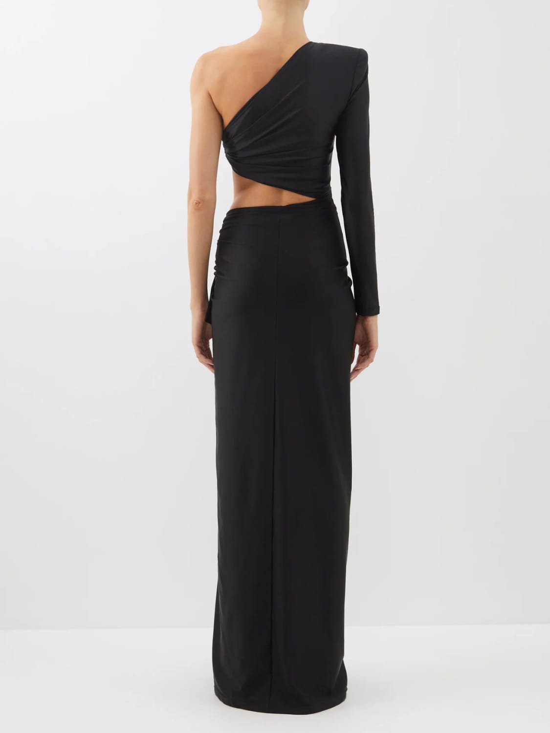 Black long sleeved hollow slit elastic shoulder dress featuring a one-shoulder design with a draped bodice and a long sleeve.