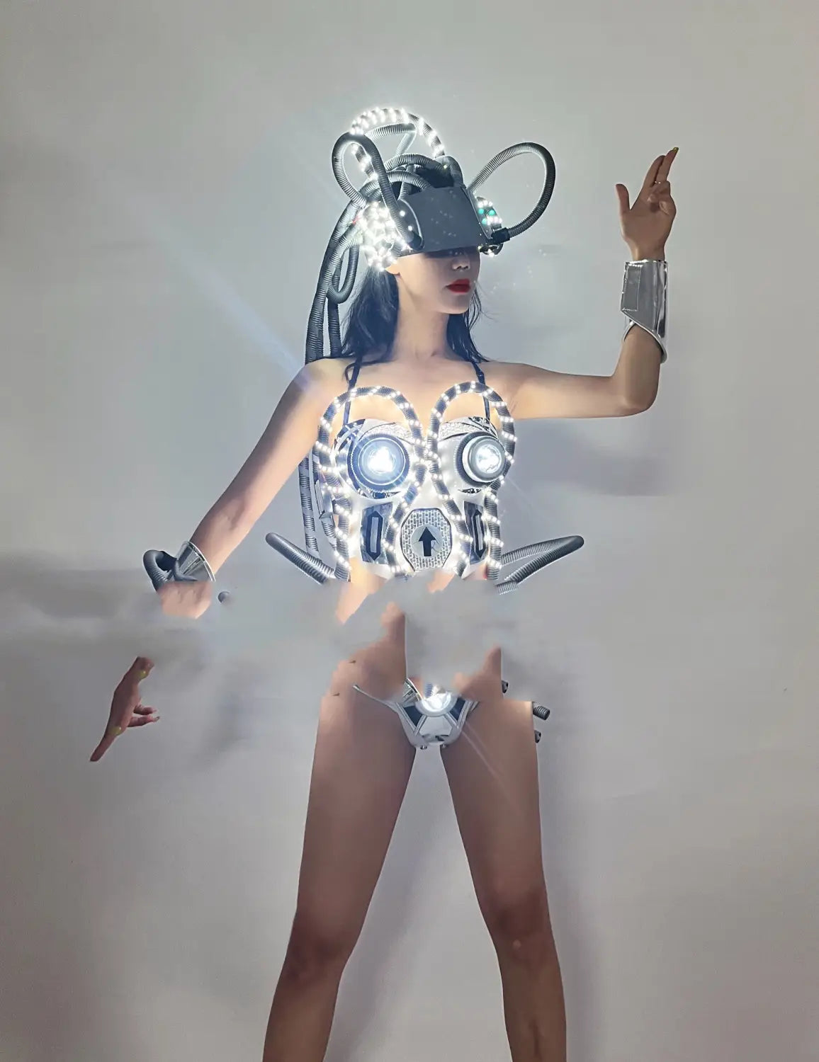 a futuristic shiny silver and black cyberpunk bodysuit featuring led luminous chest armor with glowing circular lights, intricate mechanical detailing, and a matching headpiece costume led luminous design