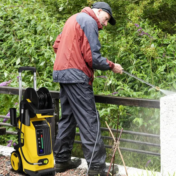 Yellow and black high pressure cleaning machine with digital display and hose reel for efficient pressure cleaning tasks.