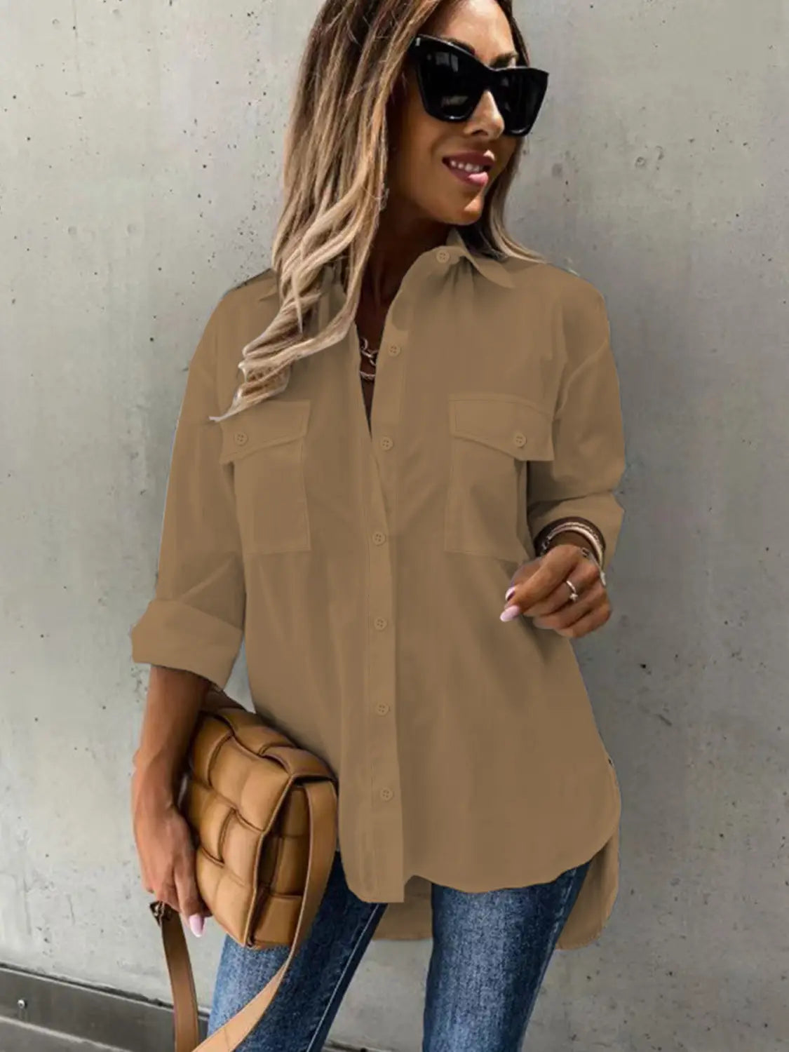 a tan quilted crossbody bag with a structured padded design and matching strap paired with a red loose long sleeve lapel button down shirt