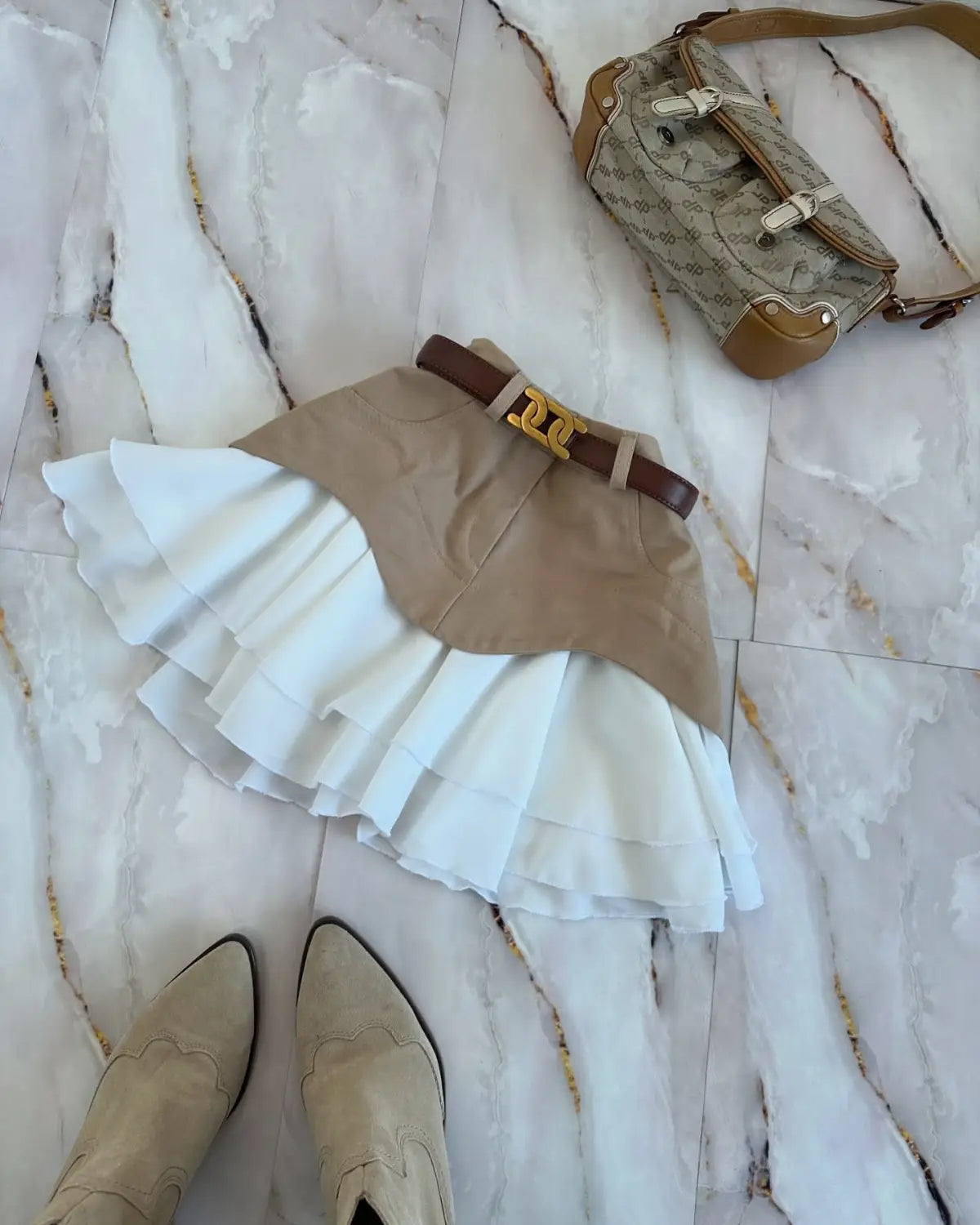 beige and white ruffled high waist tiered skirt with a brown belt and gold-tone buckle designed for elegant casual wear