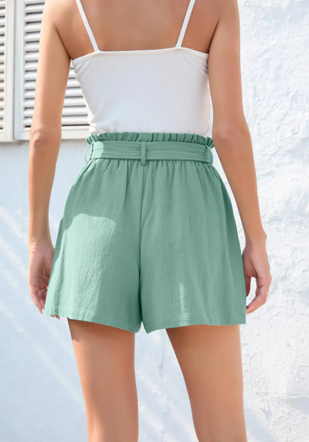 mint green high-waisted shorts with a ruffle bow waist tie, elasticated belt, thin spaghetti straps, and pockets, featuring a fashion ruffle bow design.