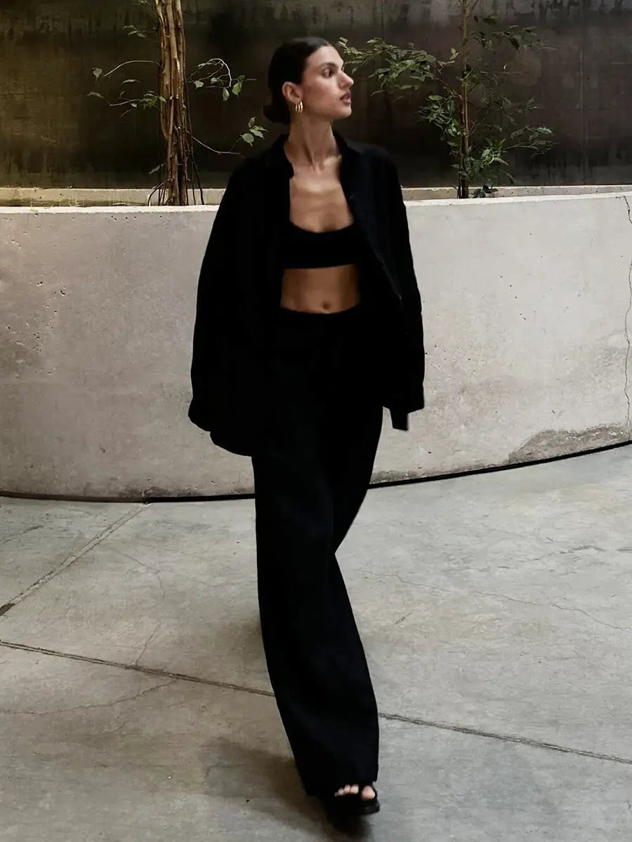 black oversized blazer with relaxed fit and structured shoulders paired with white linen long sleeve cotton shirt trousers suit