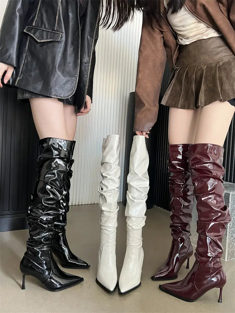 black glossy patent leather over-the-knee boots with ruched design and pointed toe featuring autumn stiletto heel pile style