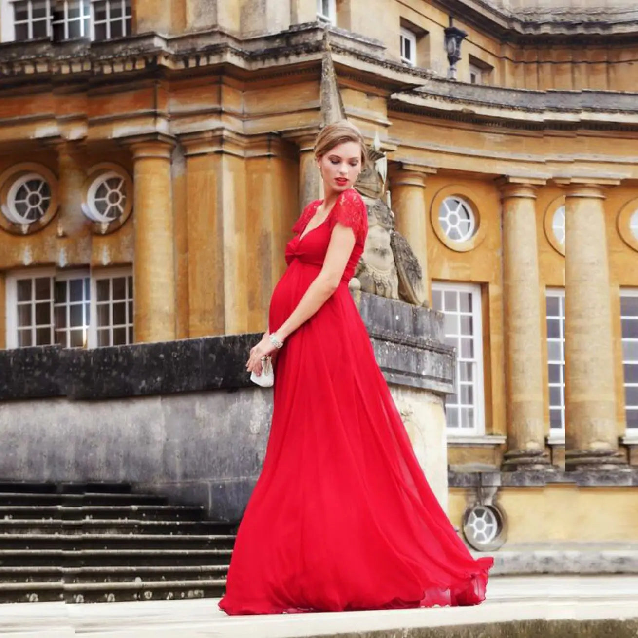 A flowing vibrant red maternity gown with a fitted bodice and sheer lace sleeves featuring eyelashes lace stitching and lace stitching Japanese cotton material for a wedding gown.