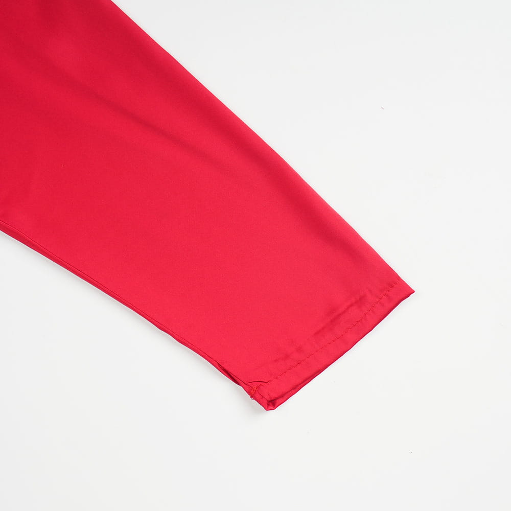 a vibrant red smooth-textured fabric sleeve with a neatly stitched hem on a plus size long sleeve sequined evening dress