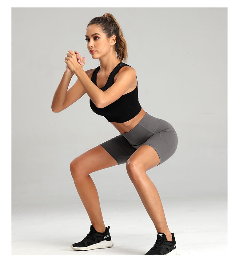 black and gray high waist fitness gym workout set featuring a fitted racerback sports bra and matching solid charcoal yoga pants paired with black sneakers with white soles