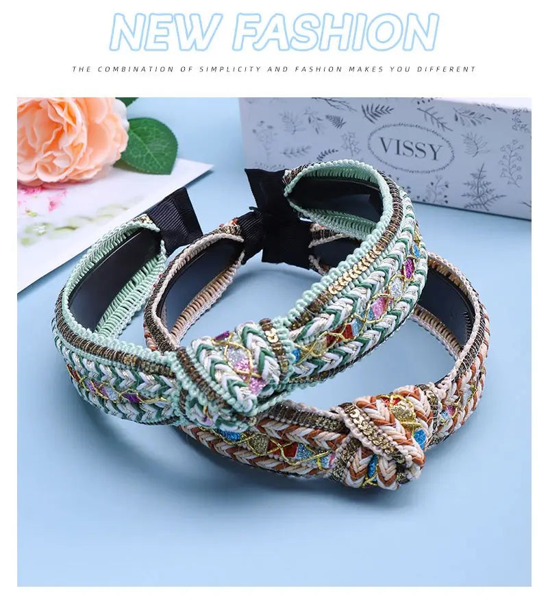 Two intricately woven mint green fabric knotted hair accessories featuring braided design and colorful embroidered details for hair accessories bohemian style.