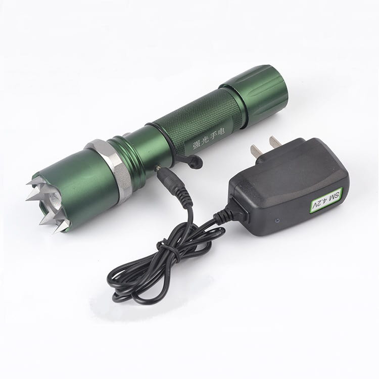 Green self-defense led flashlight with metallic spiked tip and textured grip designed for tactical use