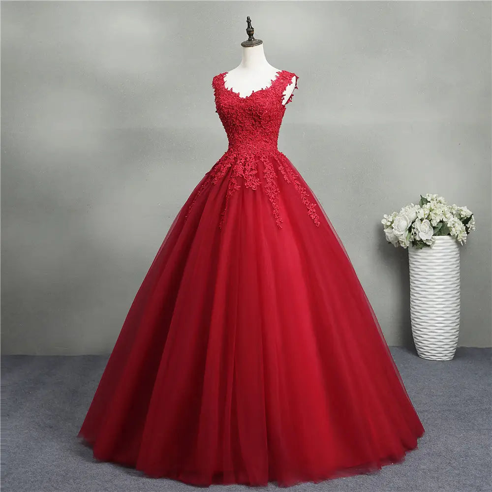 A vibrant red lace bride princess dream tulle gown featuring intricate lace detailing on the bodice and sleeves with layered tulle for a flowing silhouette.
