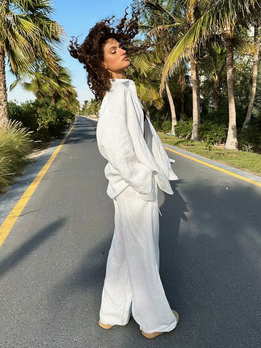 white linen pants with a relaxed wide-leg cut and subtle pleats paired with a long sleeve cotton shirt trousers suit