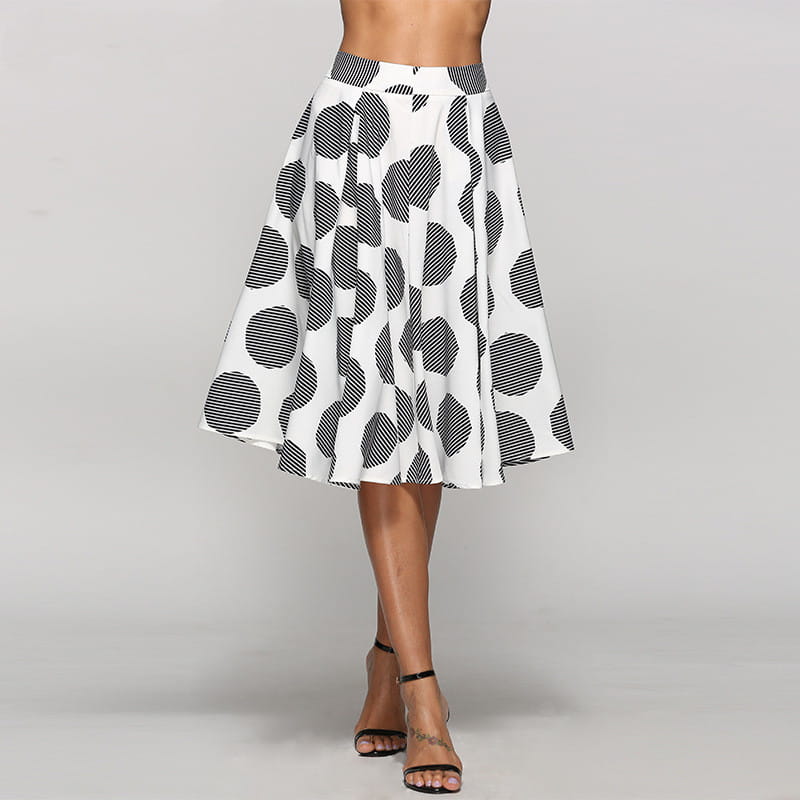 A white large polka dot round slim fit a-line skirt featuring bold black polka dots with striped interiors crafted from flowing fabric.