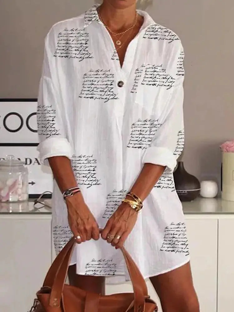 white cotton slim shirt dress featuring black cursive letter printed design and a buttoned collar