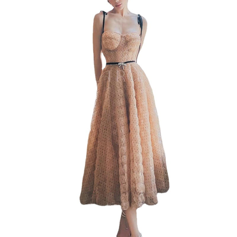 A blush pink lace slim drawstring dress featuring a delicate peach-colored corseted bodice with black straps and an elegant tiered skirt adorned with floral embroidery.