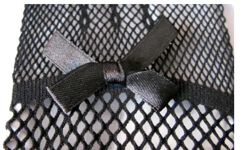 A sleek black satin bow tied neatly atop a textured black knitted stretch mesh fabric of black fishnet stretch mesh gloves with lace cuffs.