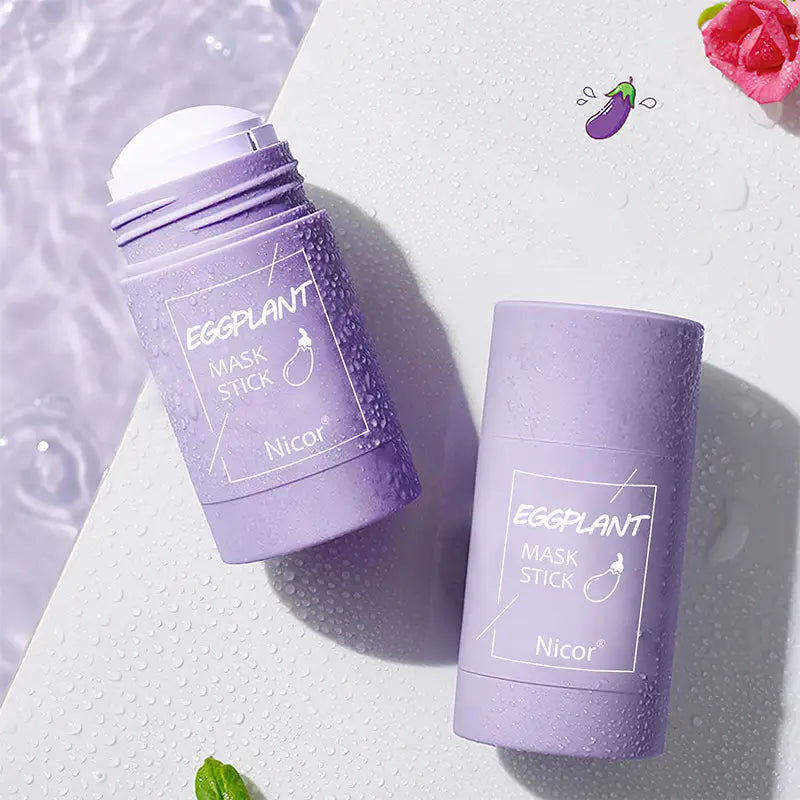 Two lavender-colored cylindrical nicor eggplant cleansing green tea mask sticks with white labeling and textured surface for oil control use.