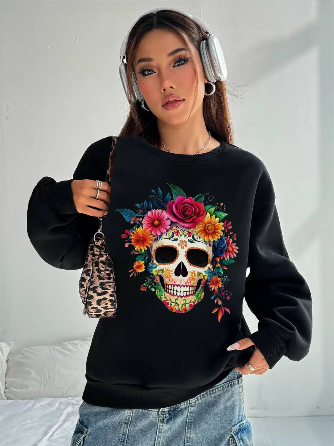 Black crew neck sweatshirt featuring a vibrant colorful floral skull design ideal for daily wear and basic long sleeve comfort.