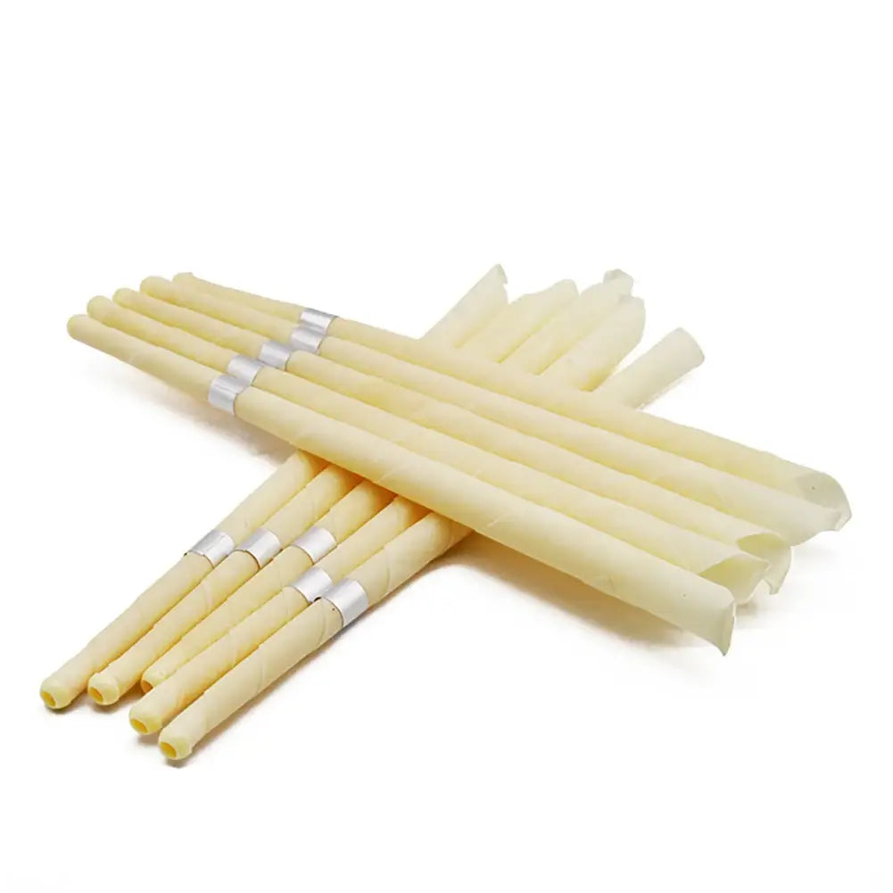 a set of pale yellow translucent coning beewax natural ear candles with silver metallic bands near the handles designed for ear healthy care and earwax removal