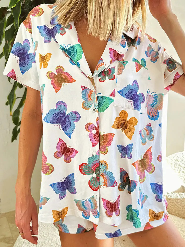 white short sleeve homewear suit featuring a vibrant butterfly print short in rainbow hues for comfortable indoor use