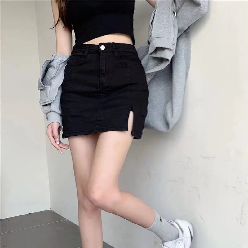 black high-waisted distressed denim skirt with a side slit made of black denim for a stylish casual look