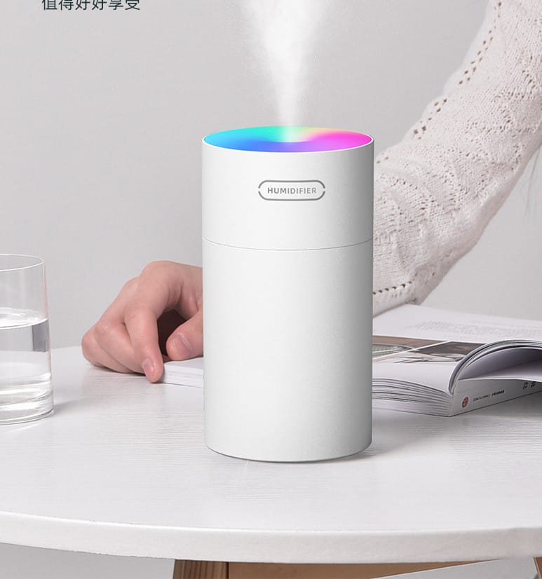 White cylindrical second generation colorful cup humidifier with a rainbow-lit top emitting mist and USB powered for personal use