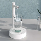 White minimalist smart desk dispenser electric water pouring clear liquid into glass for dark blue smart desk use