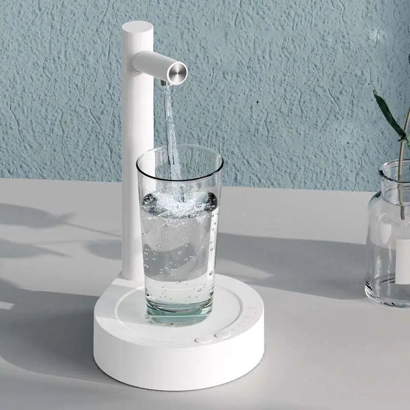 White minimalist smart desk dispenser electric water pouring clear liquid into glass for dark blue smart desk use