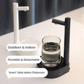 Dark blue smart electric water dispenser with sleek design and glass cup filled with water on smart desk dispenser