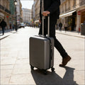 Dark gray suitcase set of three hard shell featuring a silver suitcase with textured surface and black wheels