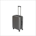A sleek dark gray hard-shell suitcase with textured surface and black wheels from a set of three gray suitcases