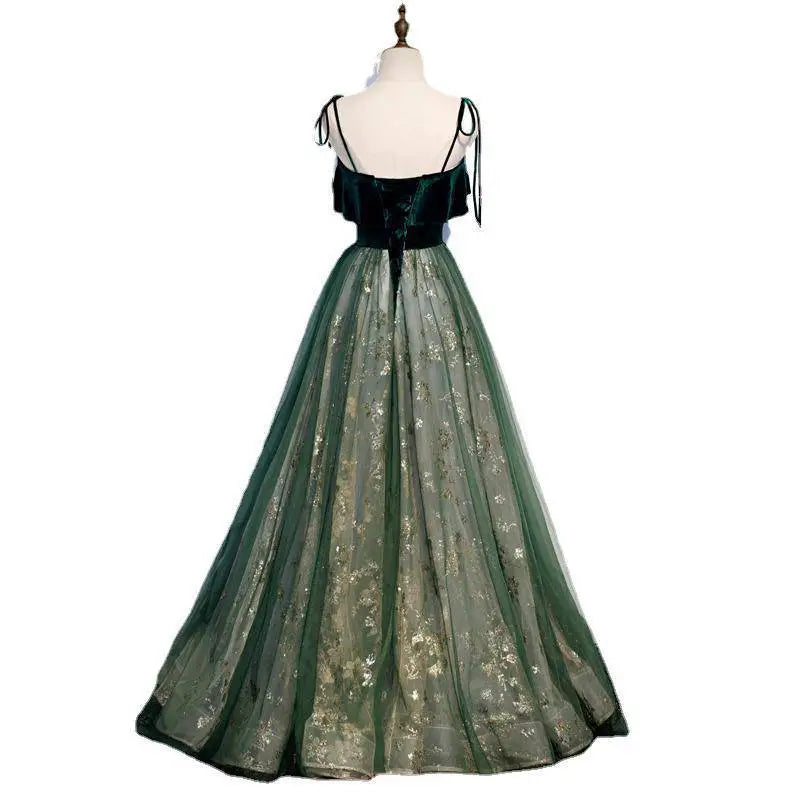 Emerald green velvet long banquet gown with gold floral embroidery on sheer tulle skirt and black tie straps sling temperament