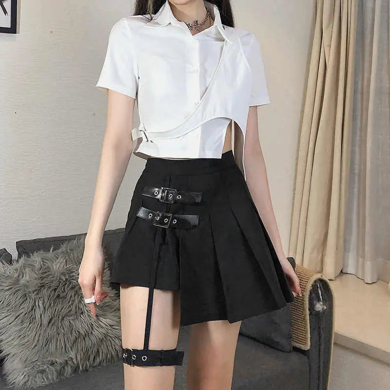 Black asymmetric pleated skirt with dark leg ring design featuring leather straps and silver buckles in ring asymmetric design