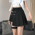 Black asymmetric pleated skirt with dark leg ring and two silver buckle straps featuring ring asymmetric design