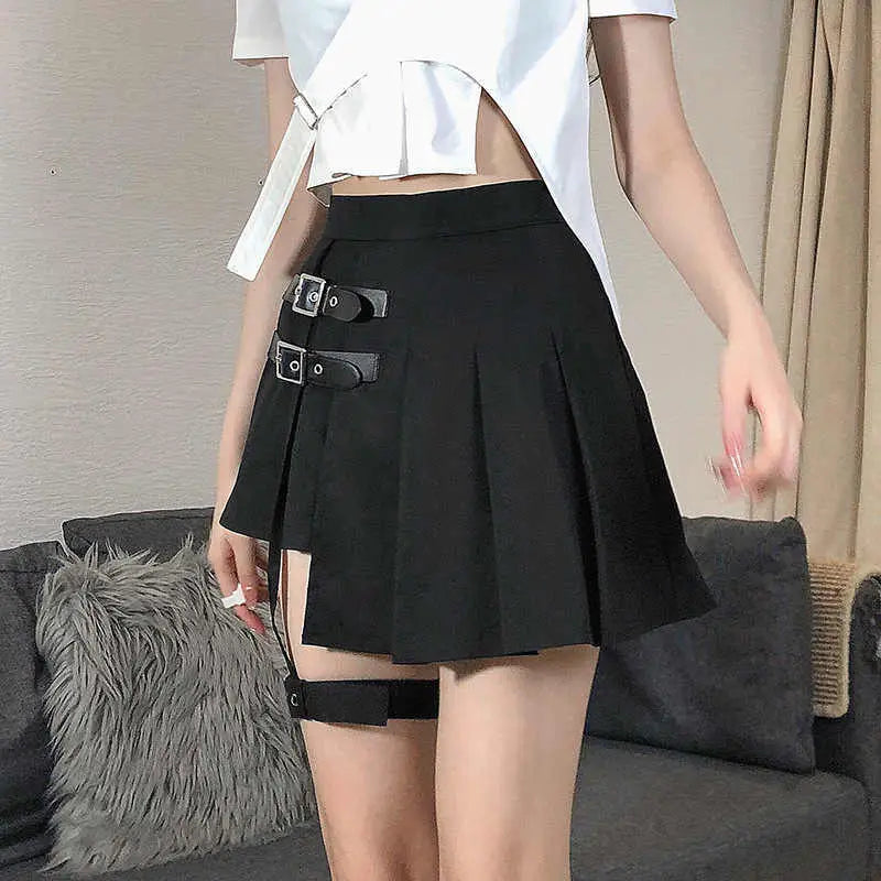 Black asymmetric pleated skirt with dark leg ring and two silver buckle straps featuring ring asymmetric design