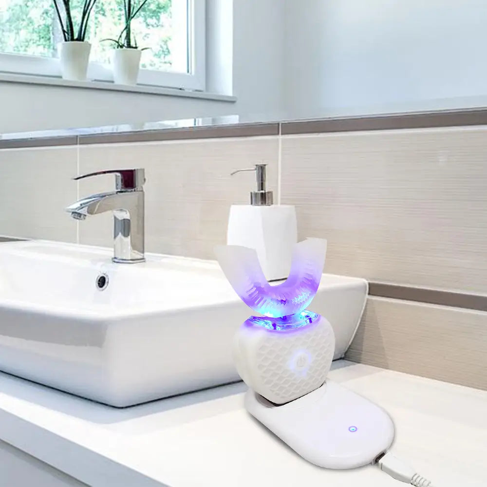 white ultrasonic electric toothbrush automatic tooth cleaner with textured charging base and glowing purple and blue led light illuminating the ultrasonic electric dental cleaning device
