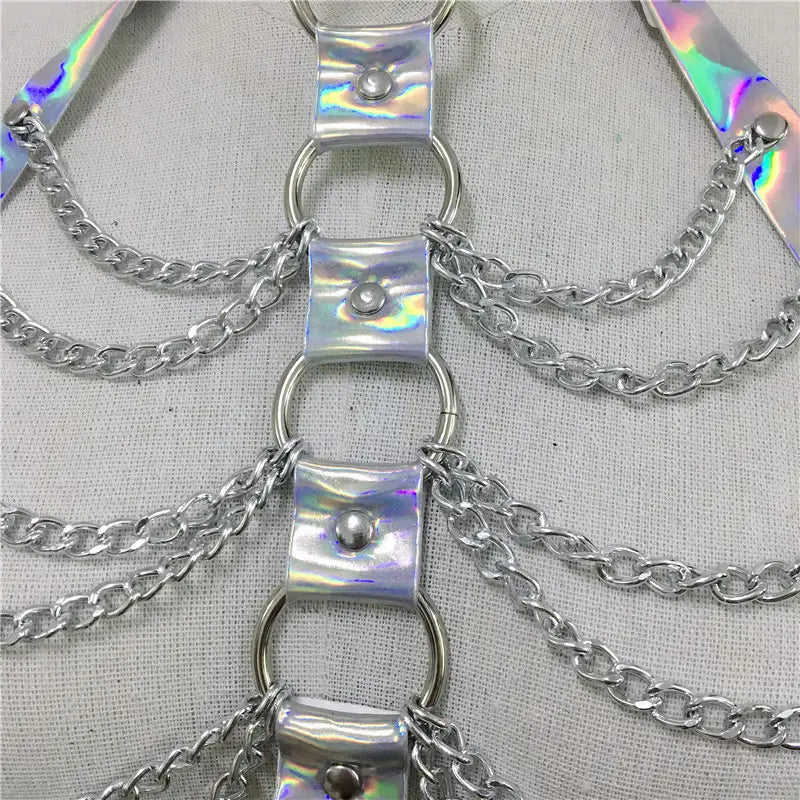 Iridescent silver chain harness with metallic rings and rectangular plates featured in a creative versatile laser ladies belt bodysuit.