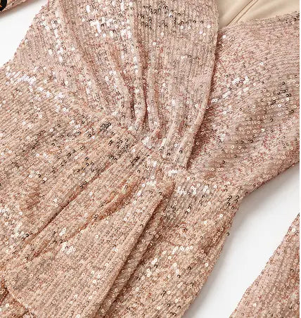a shimmering rose gold sequined fantasy celebrity sexy high slit evening dress with a fitted bodice and ruched detailing