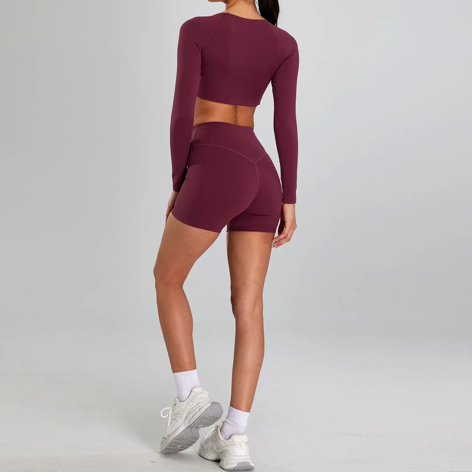 maroon long-sleeved crop top and matching high-waisted shorts sports suit outdoor designed for outdoor running nude use