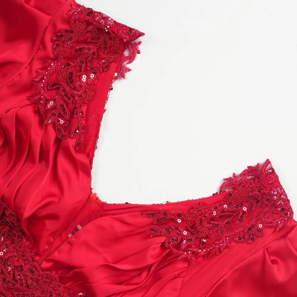 A vibrant red satin plus size long sleeve sequined evening dress with intricate lace and sequin embroidery along the neckline.
