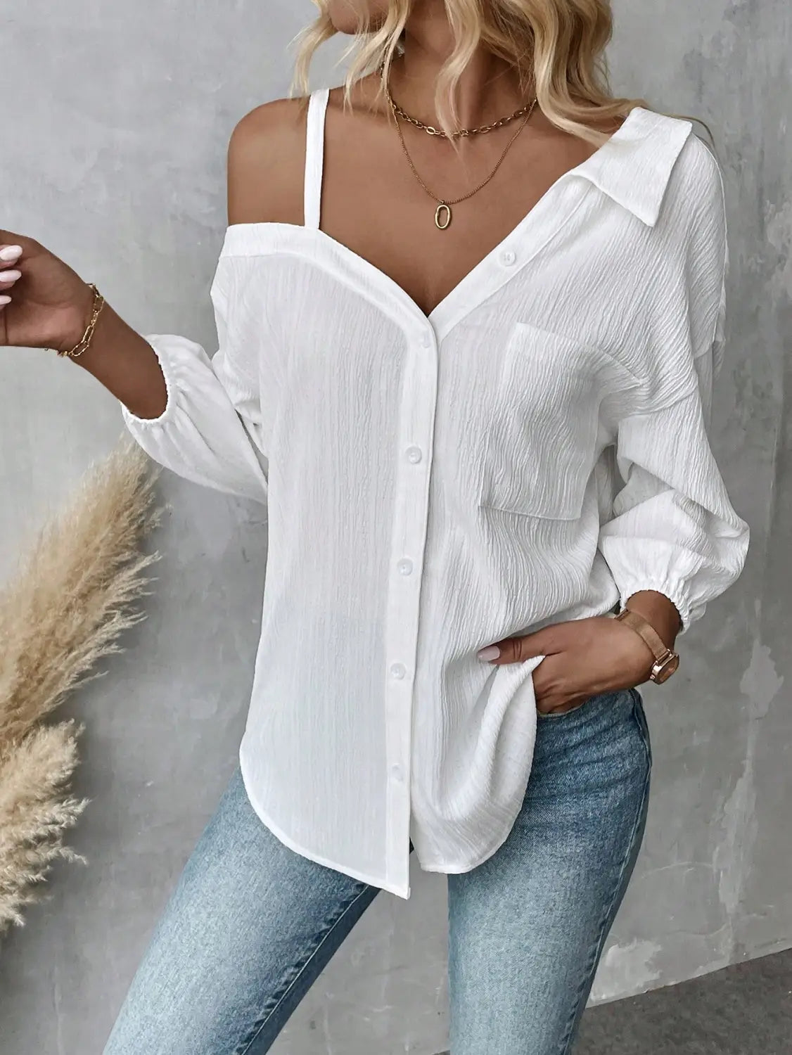 white asymmetric off shoulder blouse in solid color white with a textured lightweight fabric and long sleeves ideal for fall solid color styling.