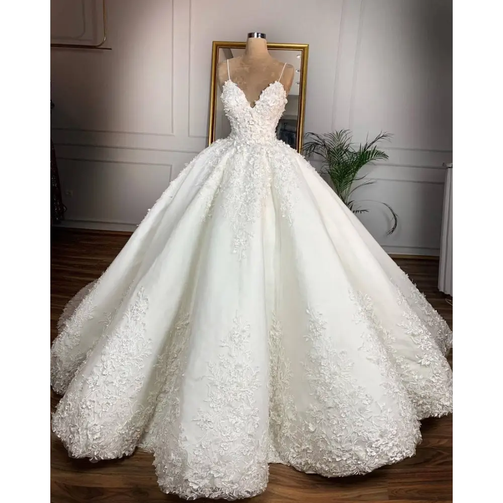 Elegant ivory lace wedding dress with deep v-neck lace and intricate floral appliqués exudes a romantic aura