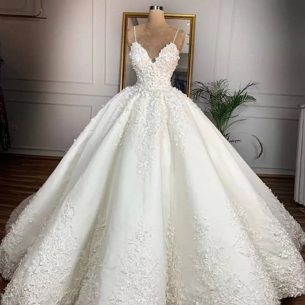 Elegant ivory lace wedding dress with deep v-neck lace and intricate floral appliqués exudes a romantic aura