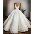 A white lace wedding dress with deep v-neck lace and intricate floral appliqués on a fitted bodice exuding romantic aura