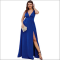 A woman wearing a royal blue deep v-neck sleeveless swing dress with a high slit and floor-length design